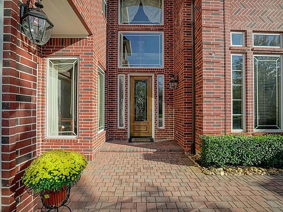 Note the pave detail leading up to the inviting front porch.