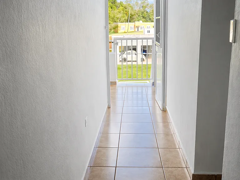 Bright and airy hallway leading to your private outdoor space.