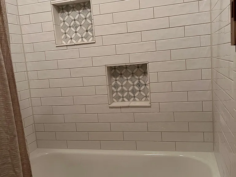 Bathroom #1 Subway tile surround with built-ins tub/shower combo.