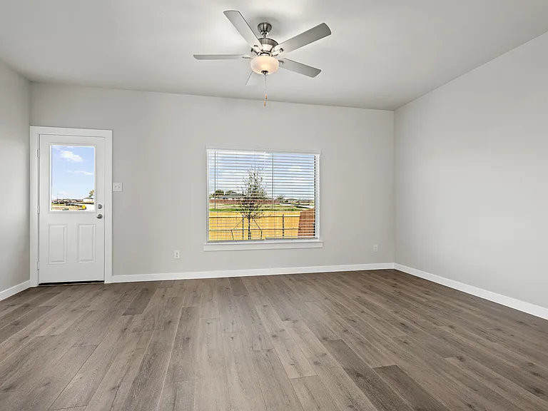 The living room has a large window that lets in great, natural light.