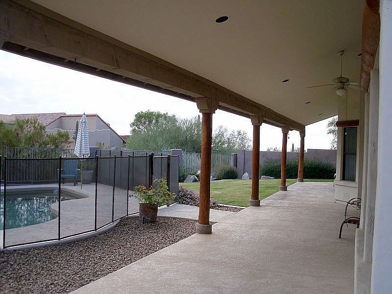 Covered patio,pool, and grassy area.