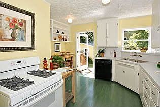 Updated kitchen with door out to deck and gardens