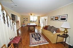 Family Room - Hardwood floors, fireplace, French doors leading to Sunroom 