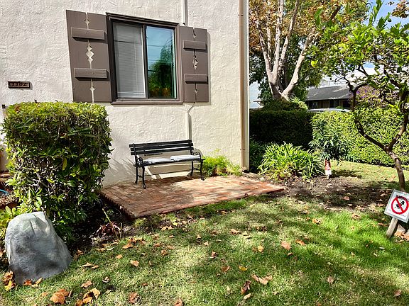 Shared patio with grassy area and fruit trees