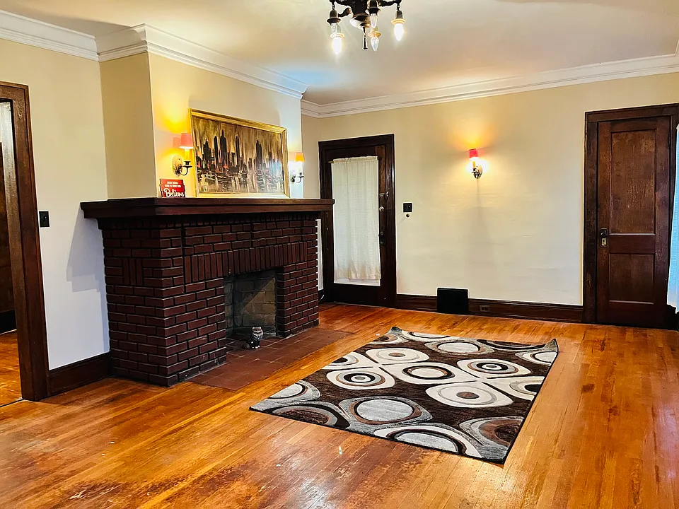 Living room with decorative fireplace and decorative wall lights