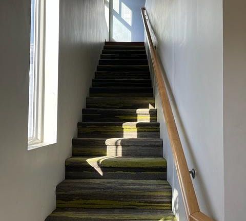 Indoor stairs going up to entrance door