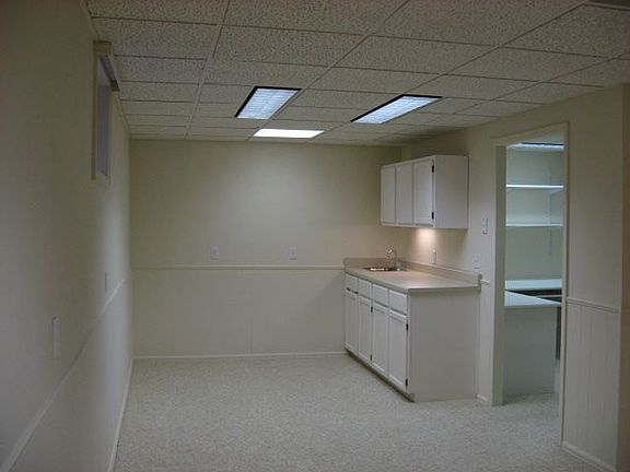 Finished basement with wetbar, workroom with bench, office, laundry room