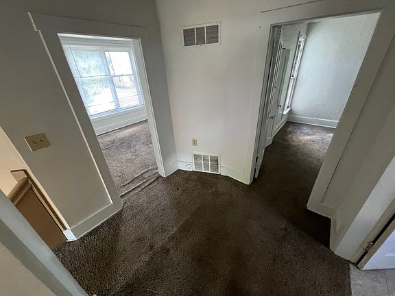 Top of Stairs looking straight into Bedroom with Living room to the left and bathroom to the right. Kitchen behind
