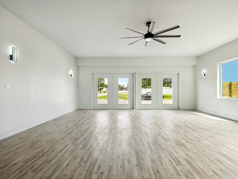 Enormous master bedroom that accommodates a sitting area and home office.
