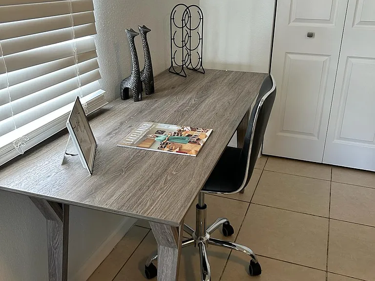 Elegant, well-lit workspace with desk and chair for work or study.