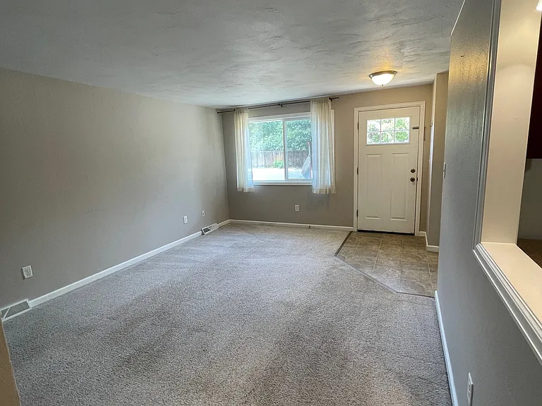 Cozy family room with pass through window to kitchen.