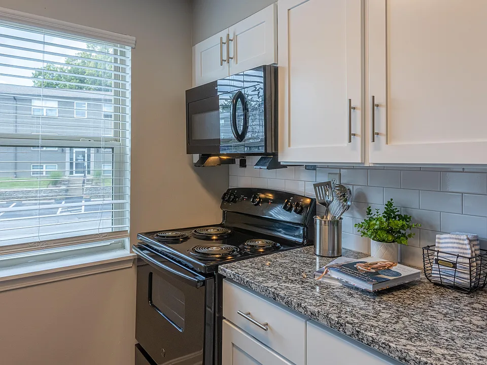 Kitchen with granite counters and black appliances