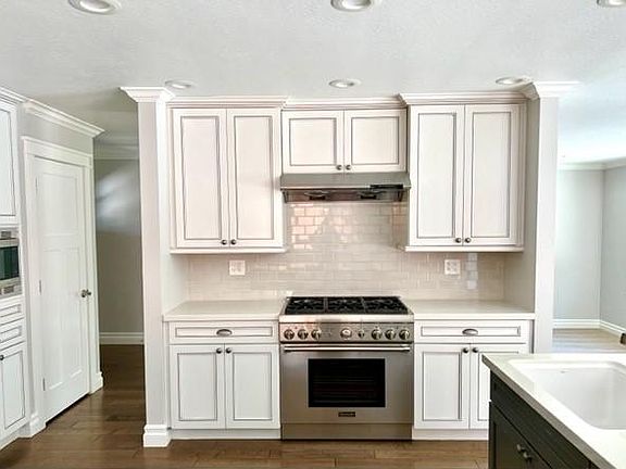 Gourmet kitchen with 6 burner high-end gas range and stove.