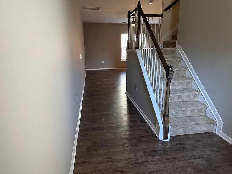 A view from the front door looking into the living area and up the stairs.