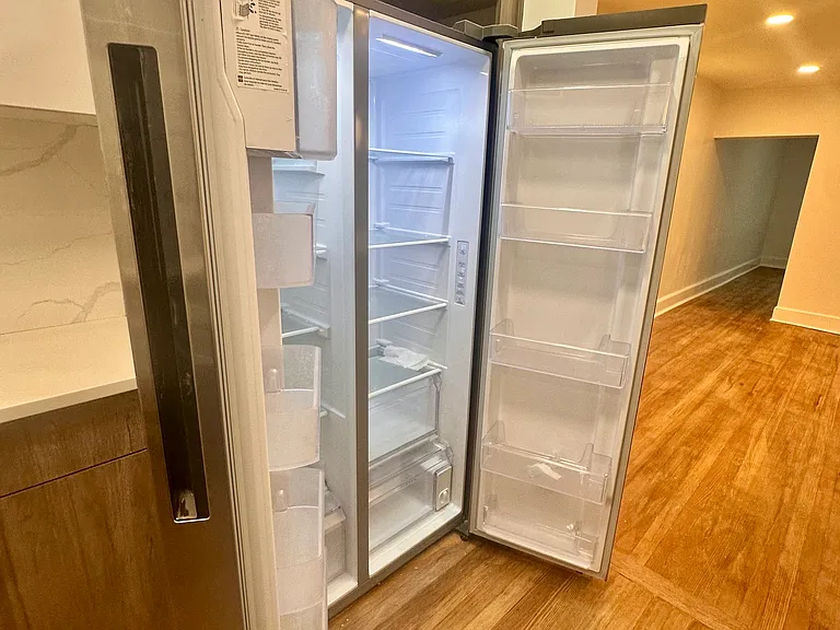 Modern kitchen with stainless appliances and Samsung fridge/freezer.
