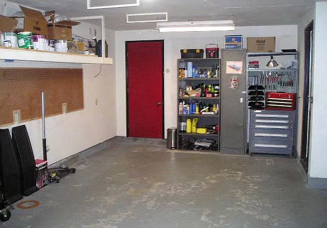Oversized garage with a room in the back(red door) that can be an office(it is carpeted and has power outlets) or extra storage.