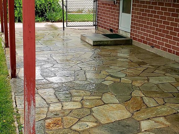 Large covered quartzite stone patio great for outdoor cooking and relaxing.