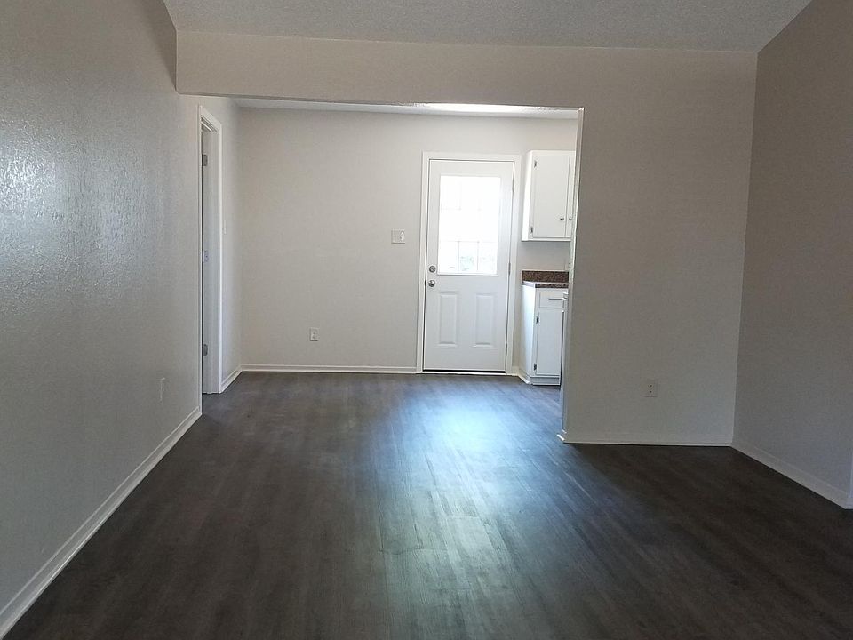 Living room has vinyl plank flooring