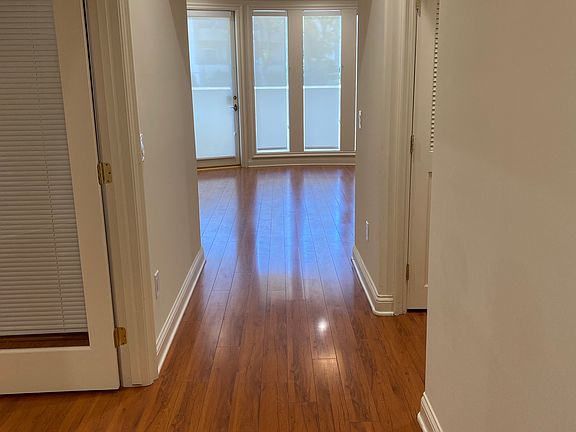 Entrance view with brand new roller shades installed in the entire unit