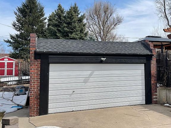 Two car detached garage. Grass backyard to the left and facing East.