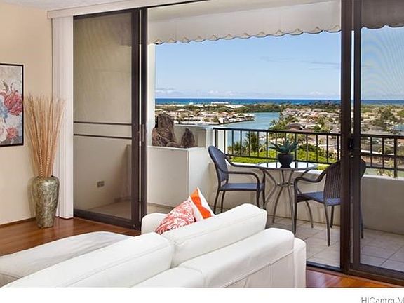 This desirable end unit features ceiling to floor sliding glass doors that open out to a covered lanai with ocean and marina views.