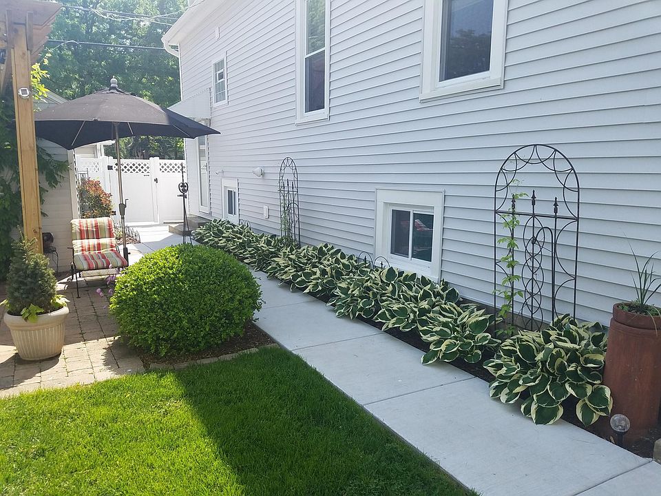 This is the back side walk leading to the back yard flower garden and exit to the paved alley. The grilling area is behind the house in a totally paved area.