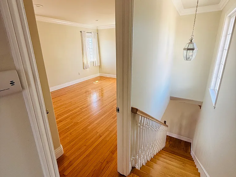 view into first bedroom and stairs