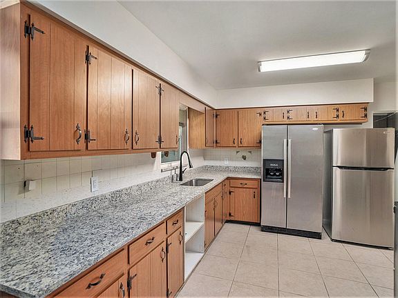 Our kitchen features a dining area and modern appliances, perfect for preparing and enjoying home-cooked meals.