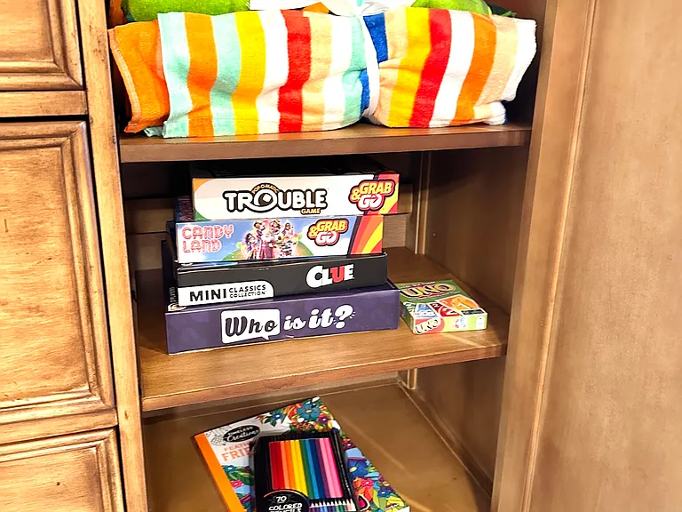 The ultimate stash of fun. _ Whether you're looking for a competitive game night, a quiet morning of coloring, or just need an extra towel for the beach, check the buffet! We've stocked it with all the essentials to keep guests entertained & comfortable.