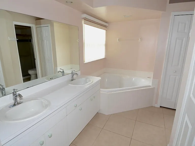 Master bathroom with garden tub and separate shower and oversized walk-in closet.