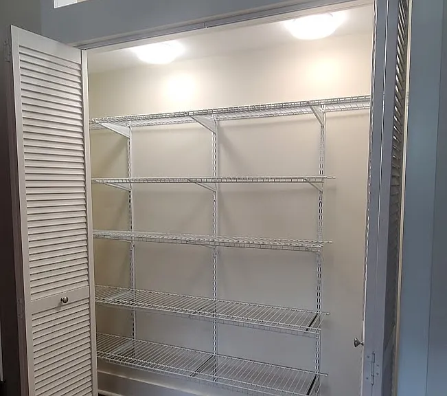 Large pantry with adjustable shelving and lighting.