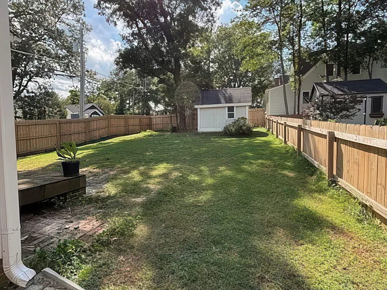 Large, fenced in backyard, with shed for extra storage