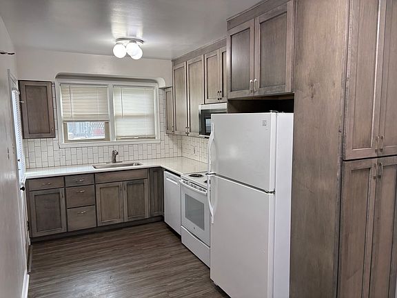 Brand new kitchen with tile backsplash and Quartz countertops.