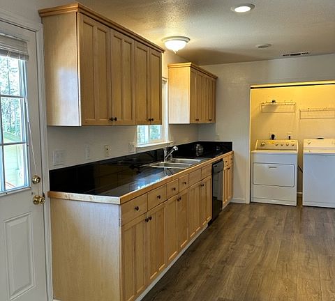 Light and bright kitchen with indoor laundry closet.