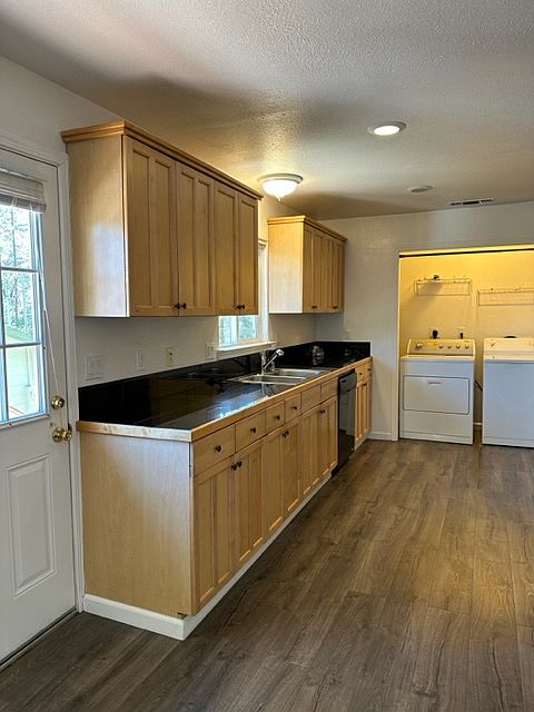 Light and bright kitchen with indoor laundry closet.