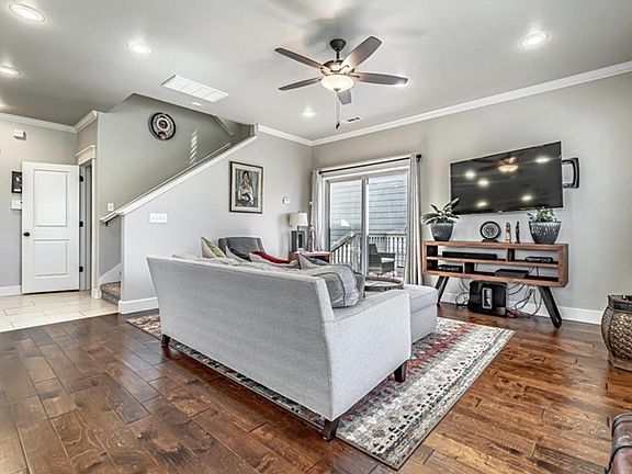Living space has wood flooring. Open door is where the half bath is.