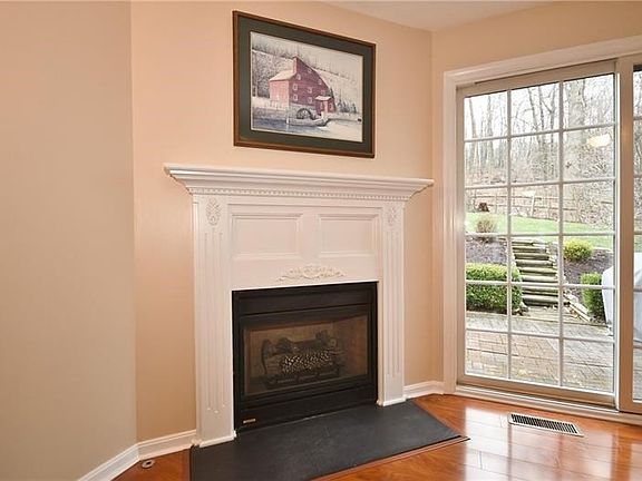 A gas fireplace means all the perks of a warm, cozy feel without the mess. Also, the back of the house looks out onto the lovely
