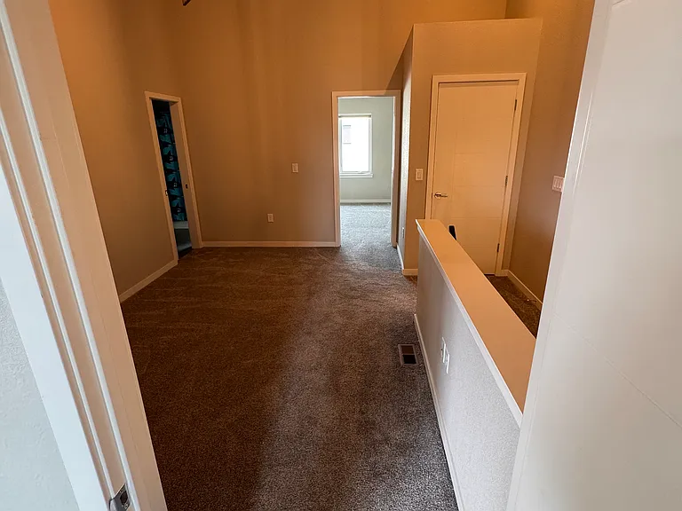 Loft area looking north. Washer/Dryer behind door on right.