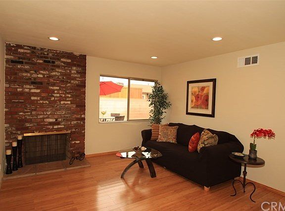 Living room fireplace shot. Window looks onto the back yard.