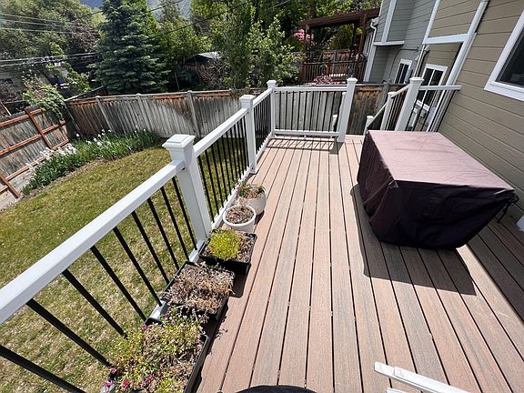 Balcony sliding glass door from kitchen. Fenced backyard.