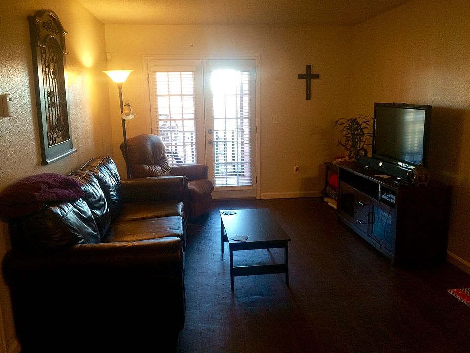 Spacious living room with wood floors and french doors.