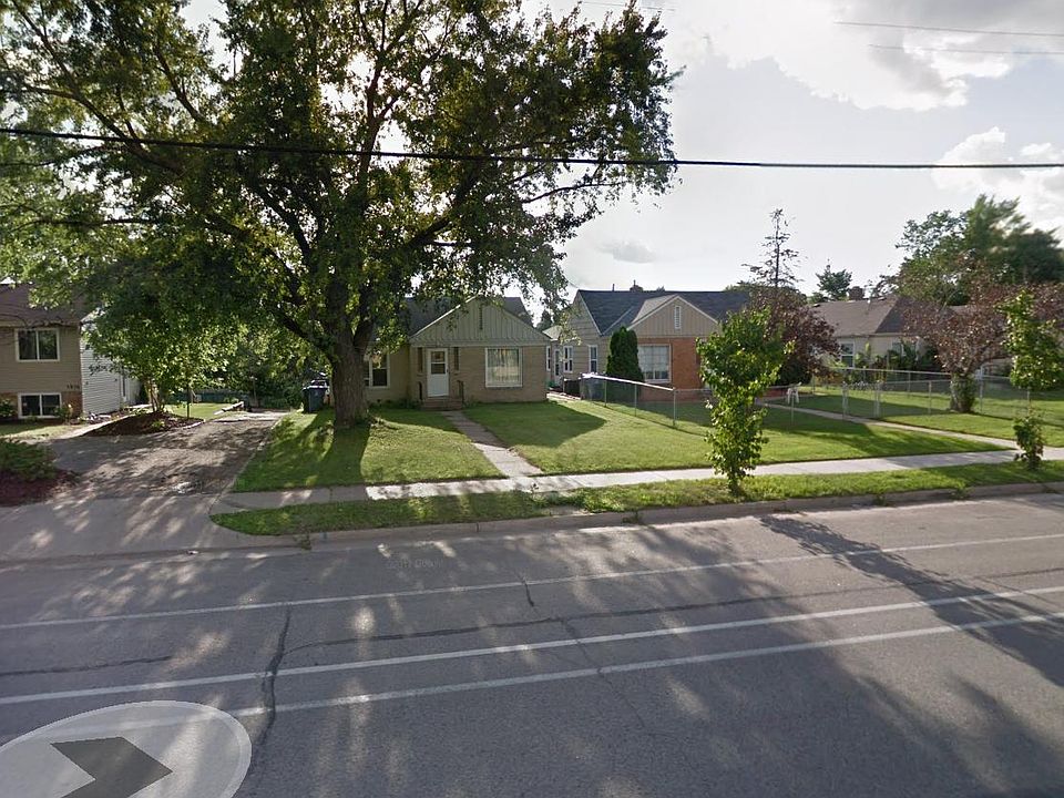 View from Lyndale. Front of house and alley leading to single tuck under garage.