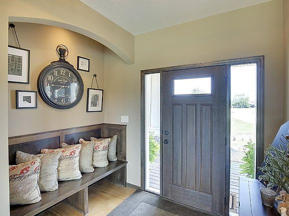 Oversized foyer with custom bench and arched ceiling