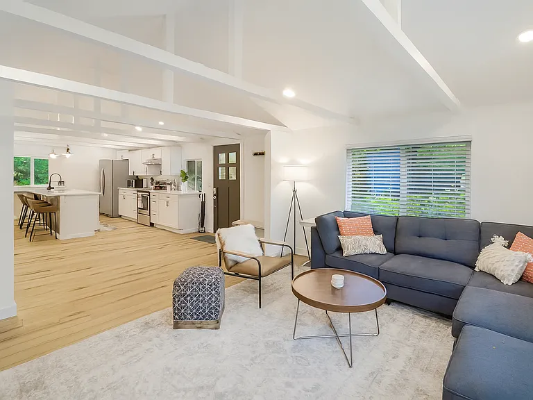 Bright and open-concept living area with vaulted ceilings and modern touches