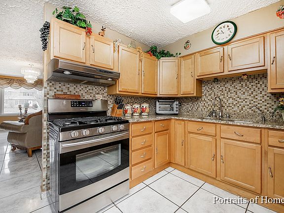 NEW STAINLESS STEEL APPLIANCES, TILE BACK SPLASH AND GRANITE COUNTERS & CABINETS
