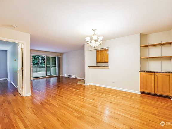 This is the vacant living room taken from the dining area. Open and bright!>