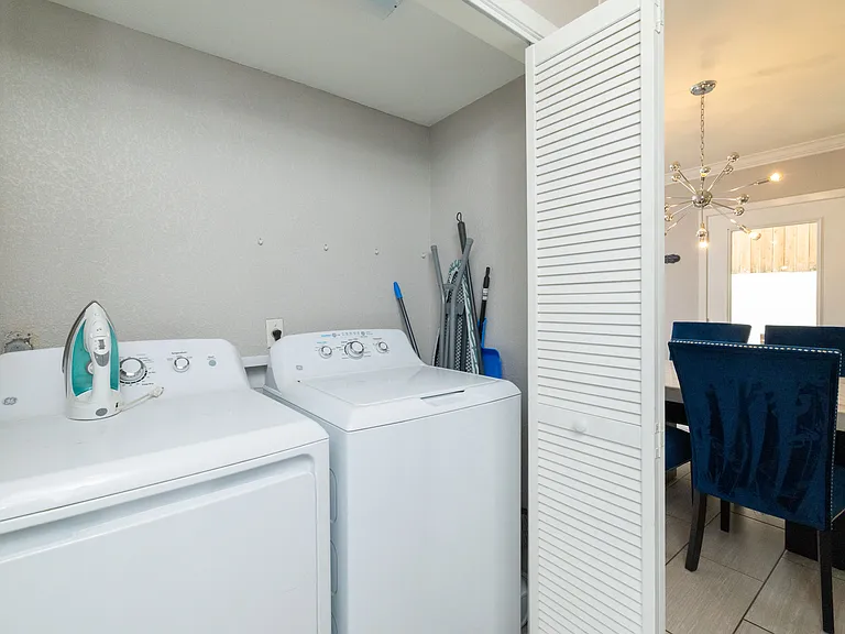 Washer, dryer, iron and iron board ready to use.