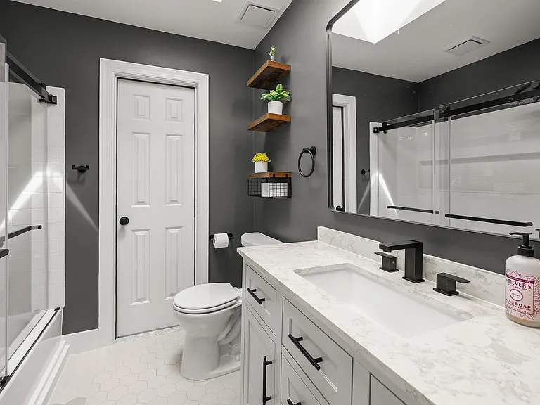 Upstairs hallway bathroom. Door access to large attic storage