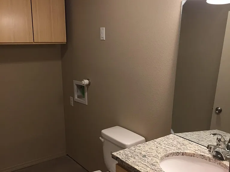 Laundry room with 1/2 bath downstairs and full-size washer/dryer.