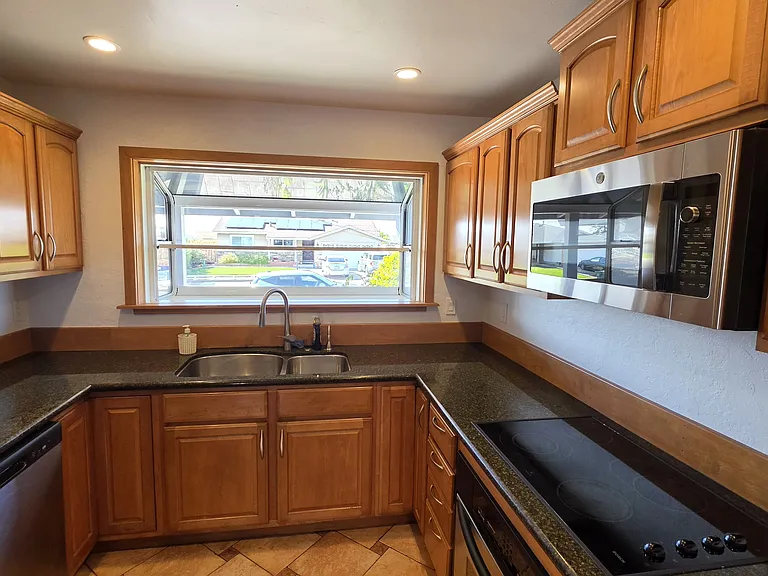 kitchen showing dishwasher next to fridge on the left
